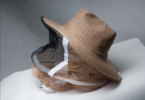 straw hat with round veil